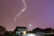 Houses with garage doors. Thunder and strike storm