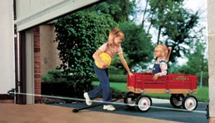 children playing under an opened garage door