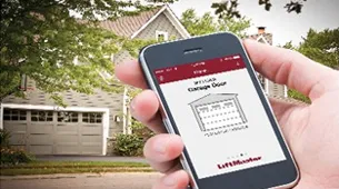 someone holding a phone in front of a garage door