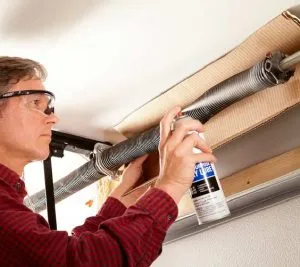 Man doing garage door maintenance