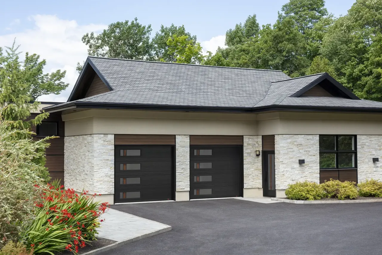 Traditional house renovated with new sidings, windows, Novatech black entry door and Garaga garage doors both with Zen Walnut glass for a contemporary look.