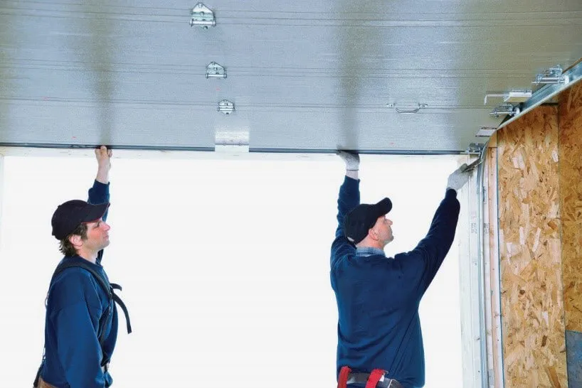 Two installers installing a garage door
