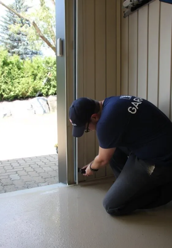 Installer installing garage door tracks