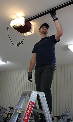 A garage door specialist make a maintenance of the LiftMaster garage door opener