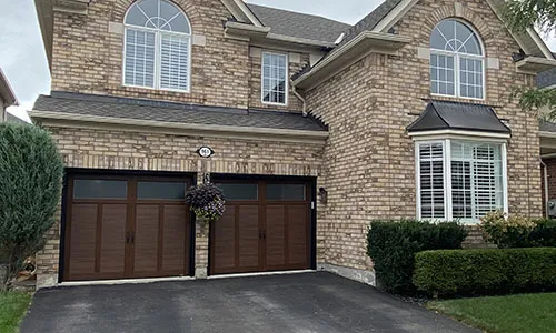 Brick house with 2 Eastman E-12 garage door, 8' x 7', Chocolate Walnut Faux Wood, Panoramic windows with Pinhead glass