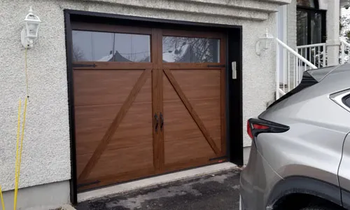 White house with Eastman E-22 garage door, 9' x 7', Chocolate Walnut Faux Wood door and overlays, 4 vertical lite Panoramic windows
