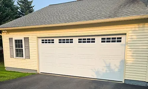 Yellow garage with North Hatley LP garage door, 16' x 7, Ice White