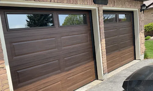 Brick house with Classic XL garage doors, 8' x 7', Chocolate Walnut Faux Wood, Clear windows